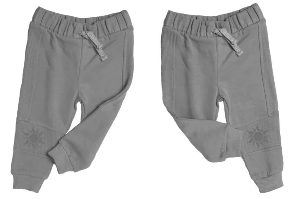 儿童运动服 一个灰色的小孩运动运动裤的特写在两个不同的视角上 分别是白色背景 孩子们的春秋时装裤 — 图库照片
