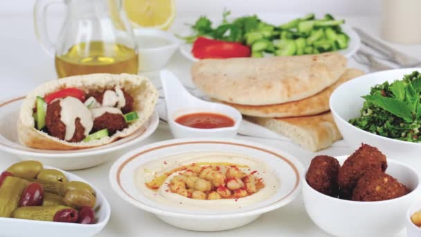 Israeli Breakfast Table Hummus Pita Falafel Tabouleh Olives Vegetables — Stockvideo