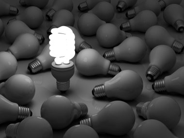 One glowing compact fluorescent light bulb standing out from the unlit incandescent bulbs clipart
