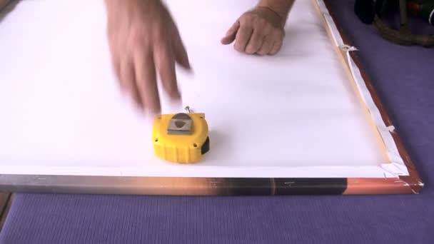 Drilling a marked hole to put in a screw to hang a picture frame. — Stock Video