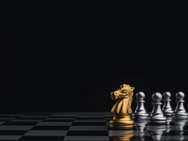 The gold horse, knight chess piece standing with falling silver pawn chess  pieces on chessboard on white background with copy space. Leadership,  winner, competition, and business strategy concept. Photos