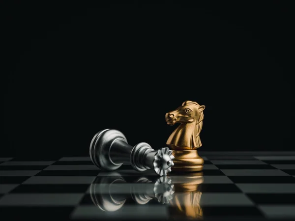 一个金色的骑士 站在黑暗背景的棋盘上的下坠银后棋子旁边 与胜利并驾齐驱的马匹棋子 获胜者 勇敢的人 商业战略概念 — 图库照片