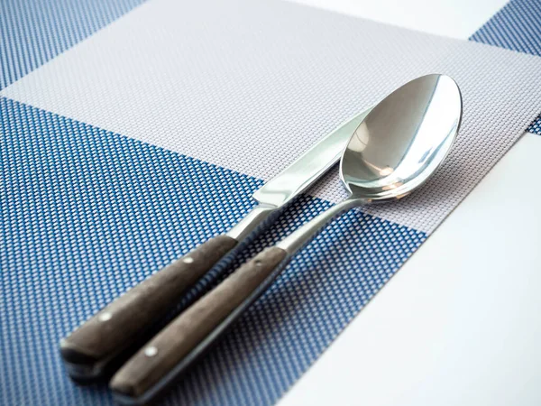 Close Spoons Knives Empty Space Blue Placemat White Table Guests — Stock Photo, Image