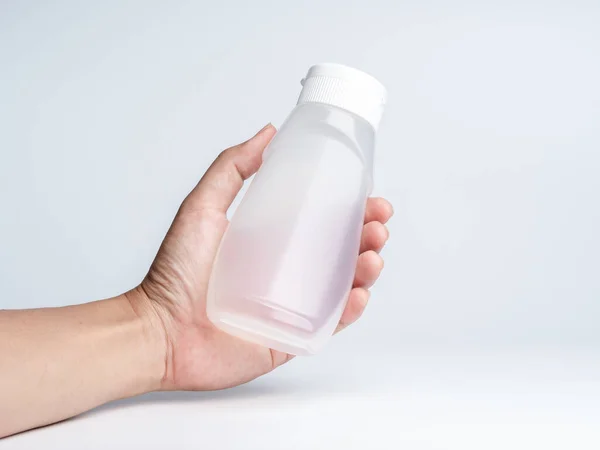 Hand Holding White Matte Plastic Bottle Curved Shape Dispenser Sauces — стоковое фото