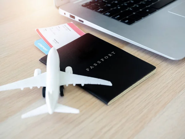 Close Passport Black Cover Flight Ticket Laptop Computer White Airplane — стоковое фото