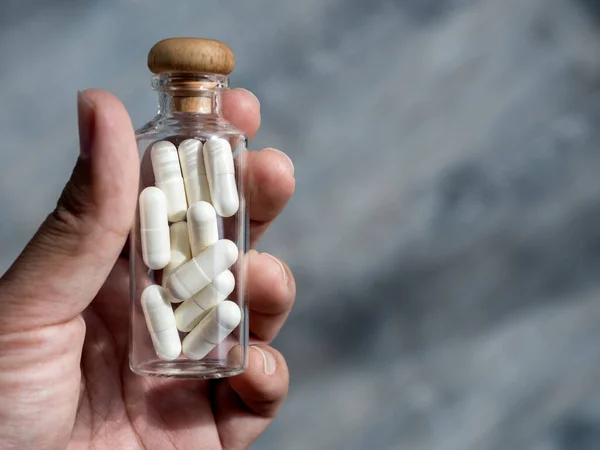 Close White Vitamins Supplements Small Clear Glass Bottle Vials Person —  Fotos de Stock