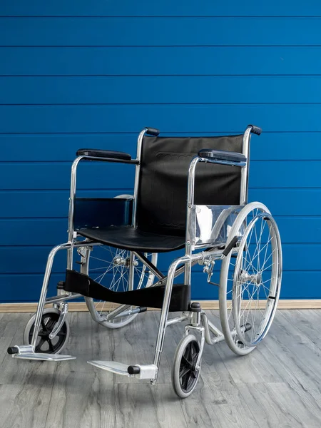 Empty Steel Wheelchair Black Leather Seat Backrest Blue Wooden Plank — Zdjęcie stockowe