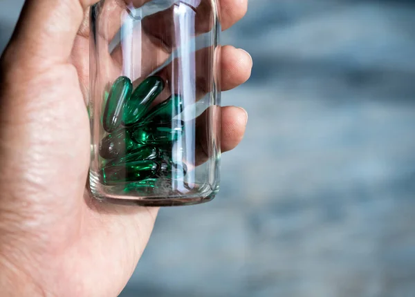 Close Green Vitamins Supplements Small Clear Glass Bottle Vials Person — 스톡 사진