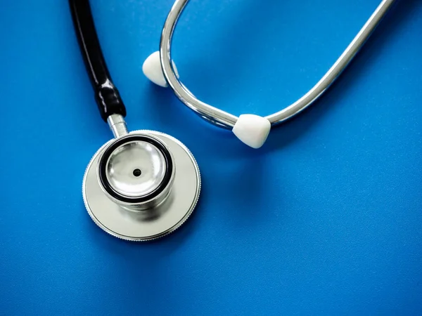 Close up stethoscope isolated on blue background, top view. Healthcare and medical concept.