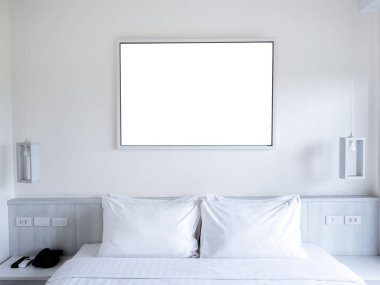 Mockup empty blank white horizontal rectangle picture photo or art frame hanging on the white wall background over the bedhead with hanging lamps. Mock-up poster, picture, template photo frames.