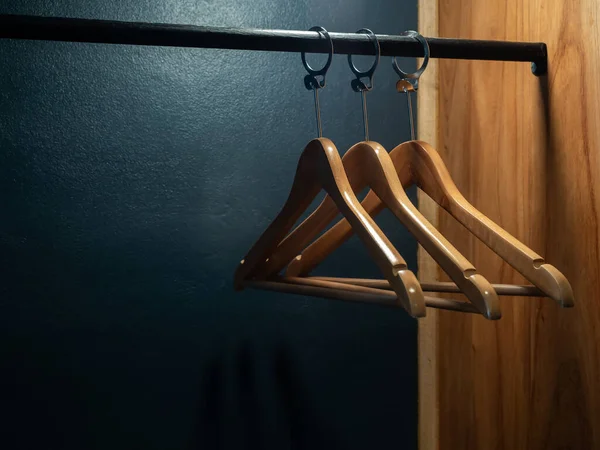 Three Empty Wooden Clothes Hangers Shirts Dress Hanging Black Cloth — Stock Photo, Image