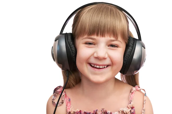 La chica sonriente en los auriculares — Foto de Stock