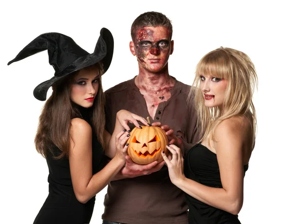 Vampiro, zombi y bruja sosteniendo una calabaza Imágenes de stock libres de derechos