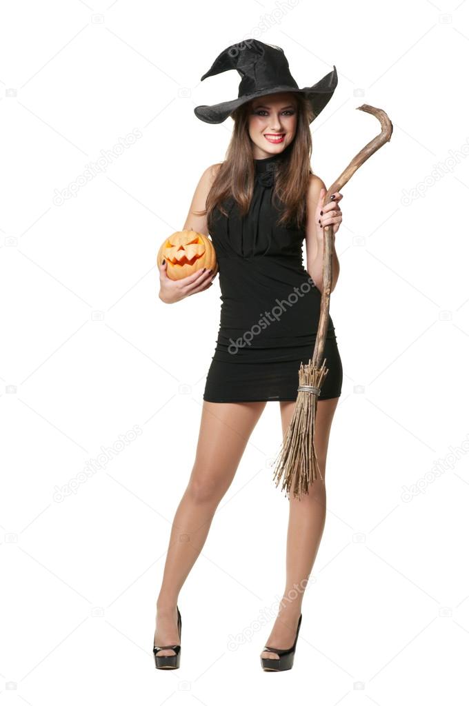 The young brunette witch with a broom