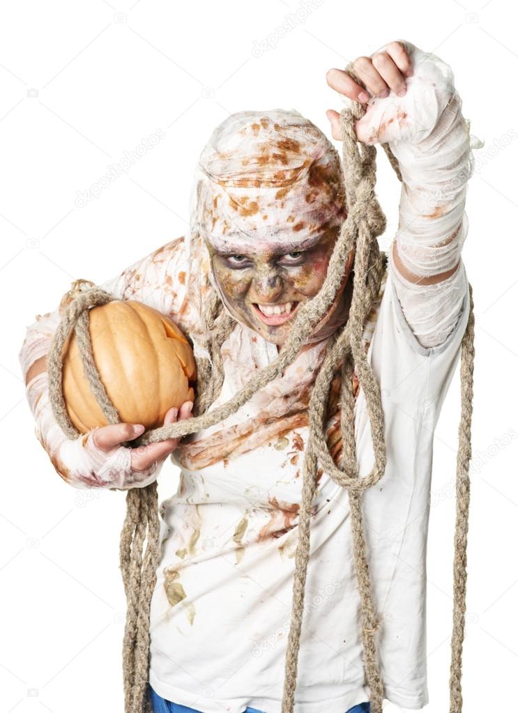 evil mummy is holding pumpkin
