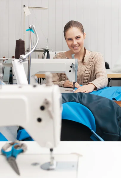 Young smilling seamstress at work — Stock Photo, Image