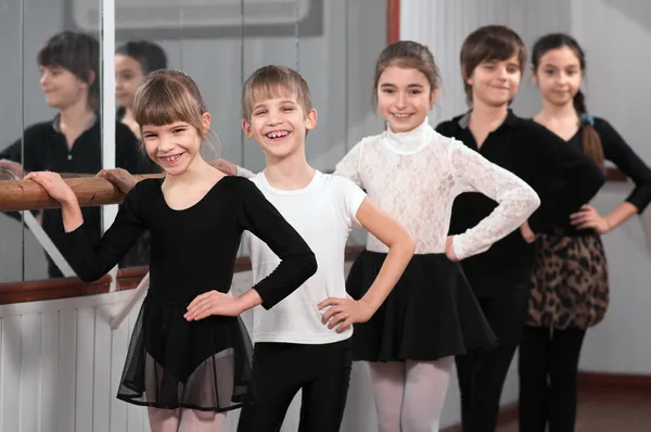 Group of children standing at ballet barre Stock Image
