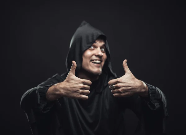 Guy in a black robe showing thumbs up — Stock Photo, Image