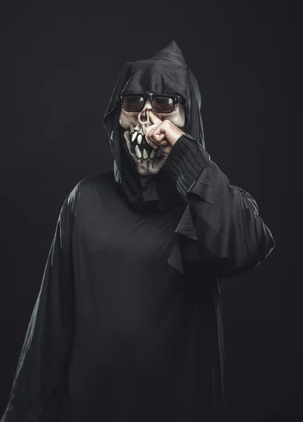 Skeleton in a robe picks his nose — Stock Photo, Image