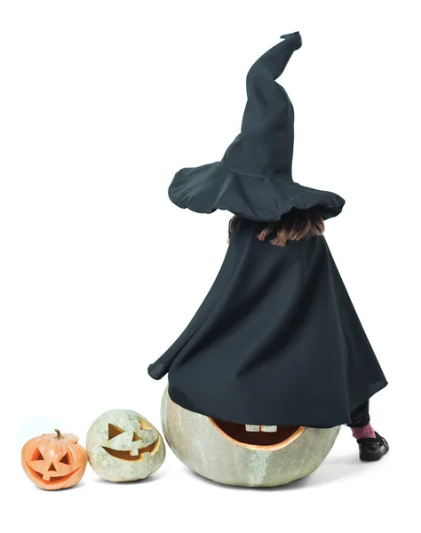 Little witch sits on a pumpkin — Stock Photo, Image