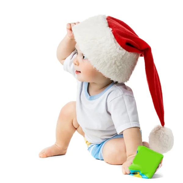 Baby peeking out da sotto i cappelli di Natale — Foto Stock