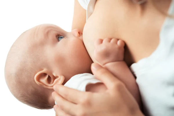 Bebé se alimenta de los pechos de mamá Fotos de stock