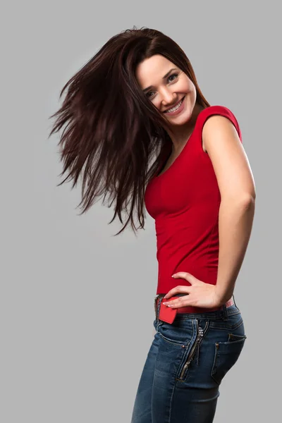 Beautiful cheerful girl with fluttering hair — Stock Photo, Image