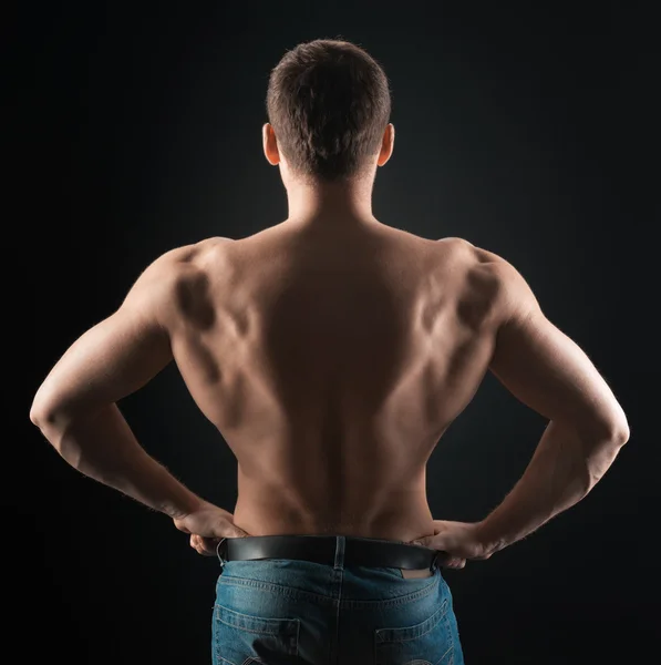 Bodybuilder shows dorsi — Stock Photo, Image