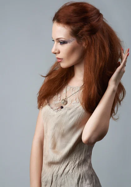 Portrait of red-haired girl on a gray background — Stock Photo, Image