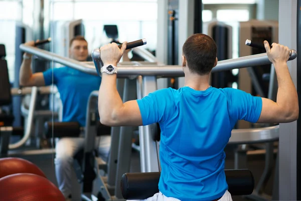 Man exercising on a simulator for dorsi — Stock Photo, Image