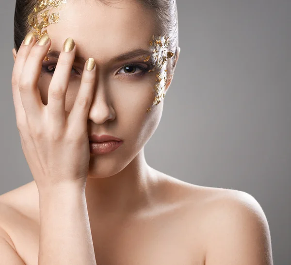 Menina bonita com arte de maquiagem dourada — Fotografia de Stock
