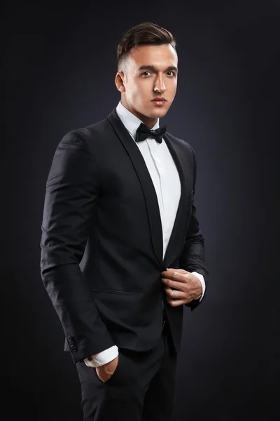 Business man in suit on a dark background — Stock Photo, Image