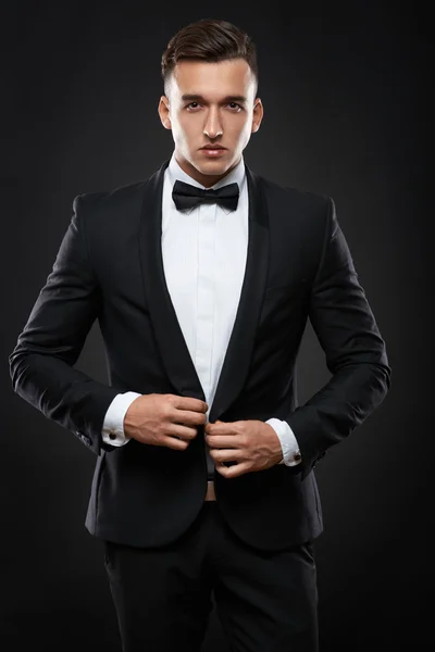 Business man in suit on a dark background — Stock Photo, Image