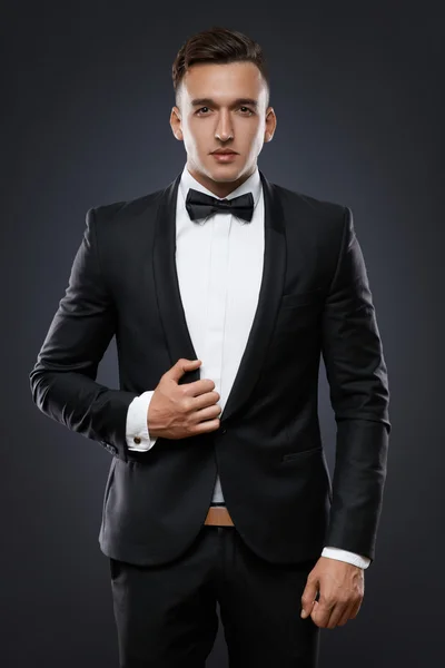 Business man in suit on a dark background — Stock Photo, Image