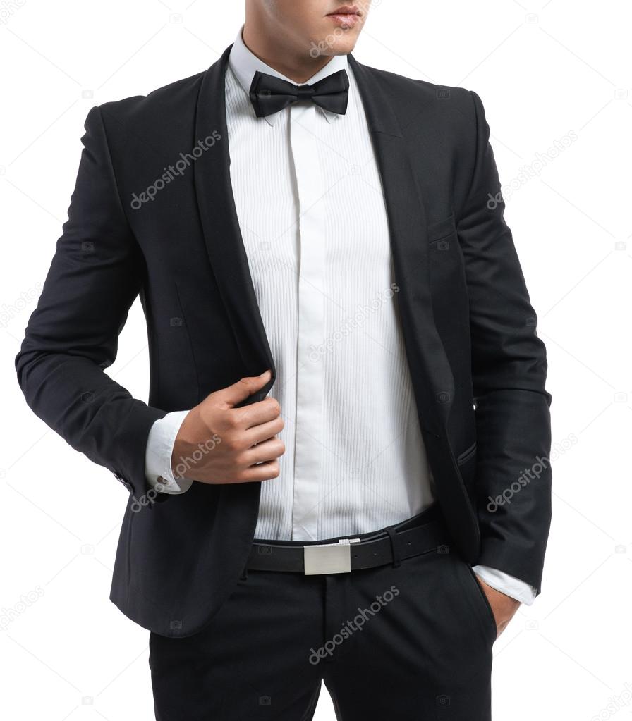 business man in a suit straightens his jacket