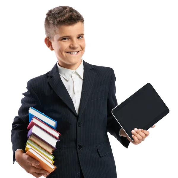 Schooljongen holding een tablet en boeken — Stockfoto