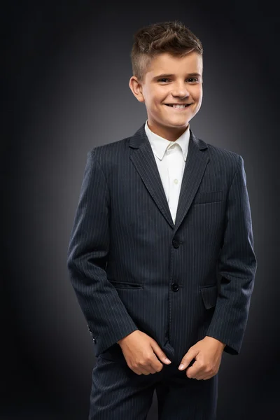 Boy in a black suit jacket corrects — Stock Photo, Image