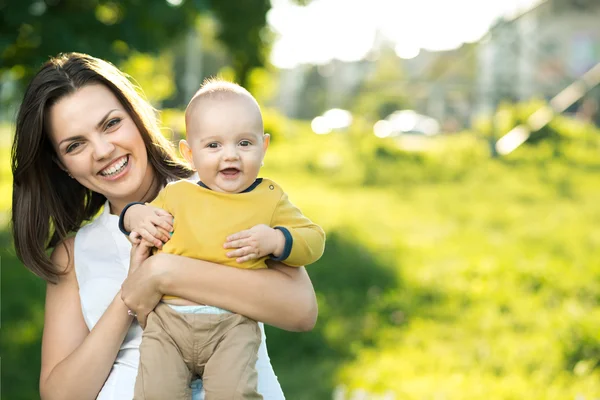 Happy mother holding a young son — Stock Photo, Image