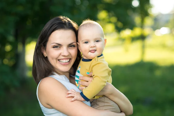 Happy mother holding a young son — Stock Photo, Image