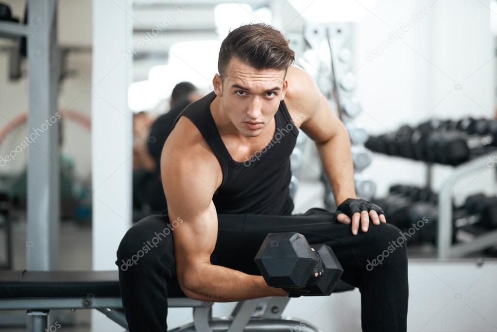 man doing exercises dumbbell bicep muscles