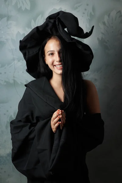 Cheerful girl in witch costume smiling — Stock Photo, Image