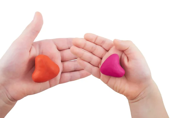 Two children's hands holding a heart-shaped heart on the isolated white background — Stock Photo, Image