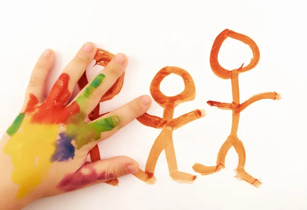 Child.Child 's hand covered in paint drawing funny little — стоковое фото