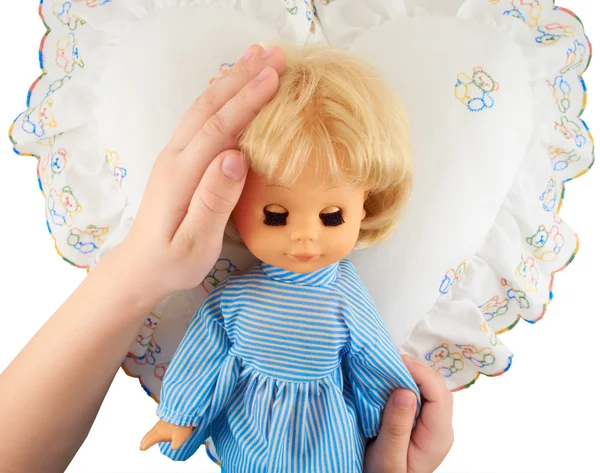 子供たちの手を枕に横になっている人形を抱きながら — ストック写真