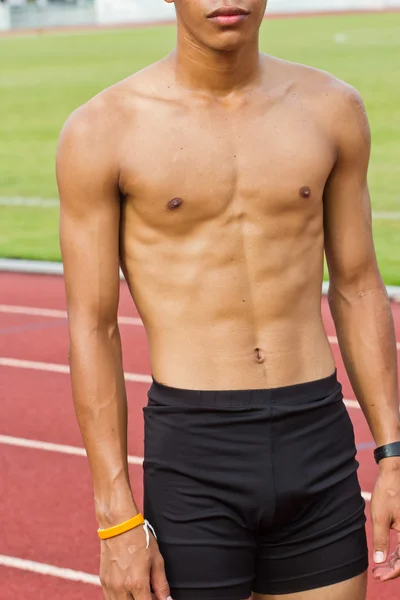 Young man with a beautiful physique thinking — Stock Photo, Image