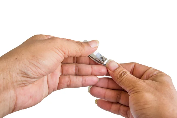 Hand manicure with nail clipper on white background — Stock Photo, Image