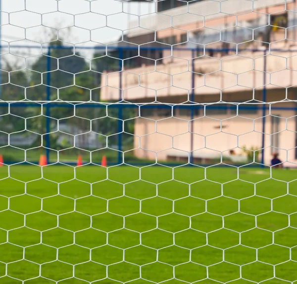 Goalpost net detail with green grass blur in background sports c — Stock Photo, Image