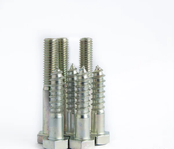 Random pile of hexagonal threaded steel bolts or screws on white — Stock Photo, Image