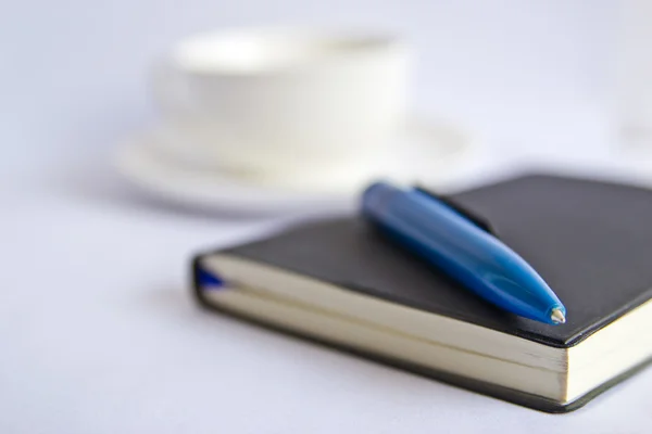 Blank notebook coffee cup on white background — Stock Photo, Image