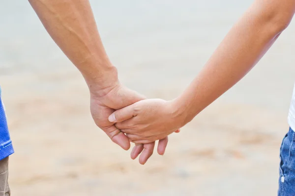 Young couple holding hands - view from back — Stock Photo, Image